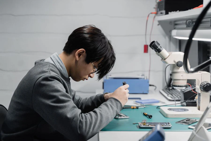 A person repairing a mobile phone