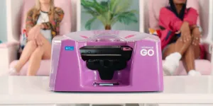 A pink nail printer and women in a salon