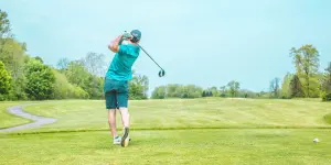 A player swinging his golf club after taking a shot