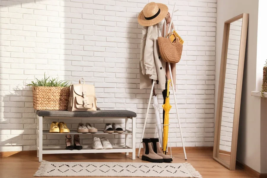 A shoe storage bench and other decor in an entryway