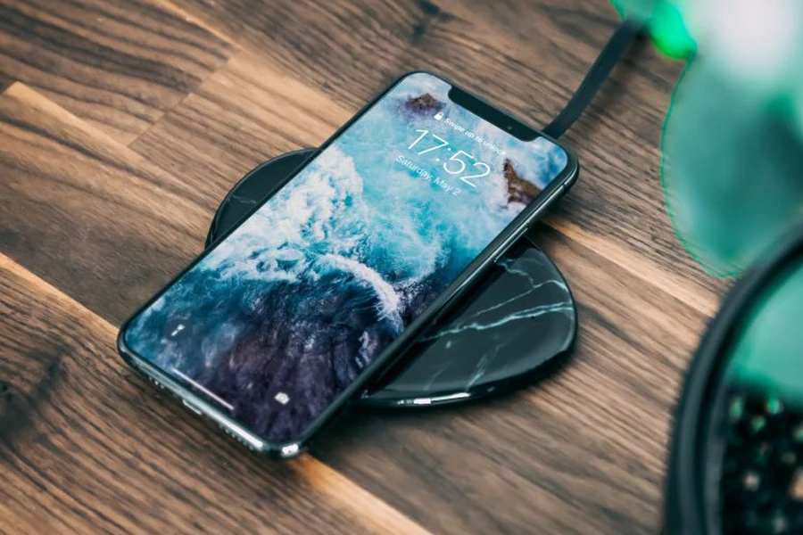 A smartphone charging using a wireless charger.