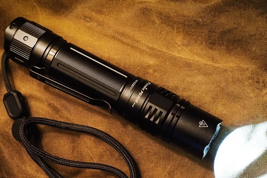 A switched-on flashlight on a table