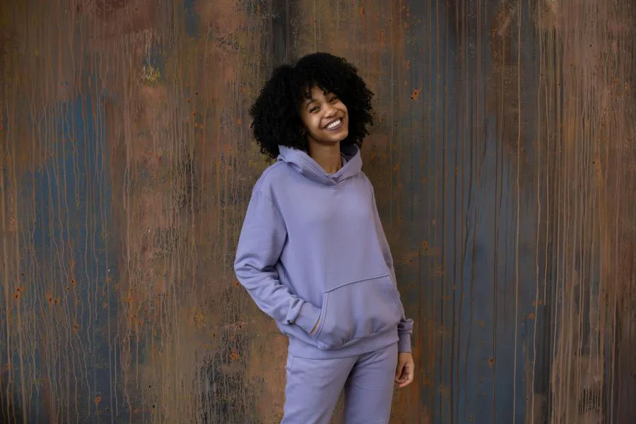 A woman in a purple velour tracksuit