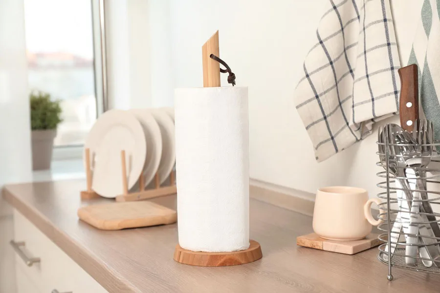 A wooden paper towel holder in a kitchen