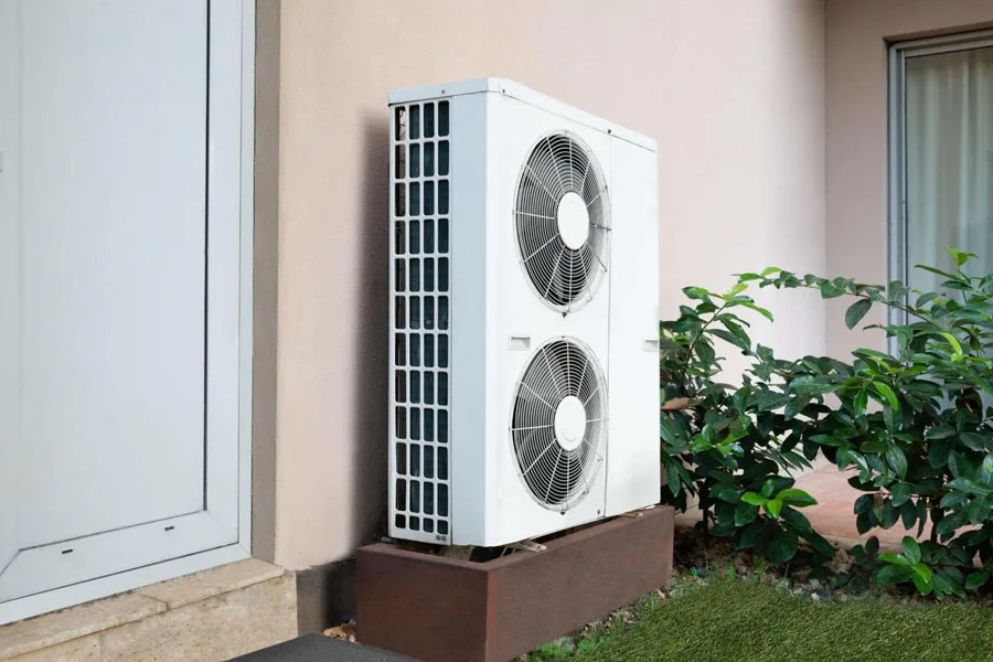 An AC unit standing outside a house