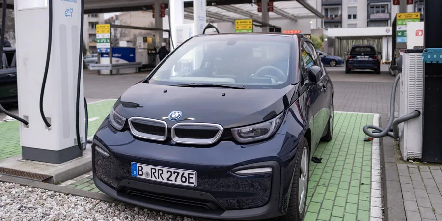 BMW i3 electric car is being charged from an electric charging station