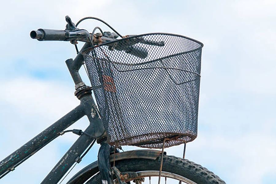 Black mesh metal bicycle basket attached to handlebars