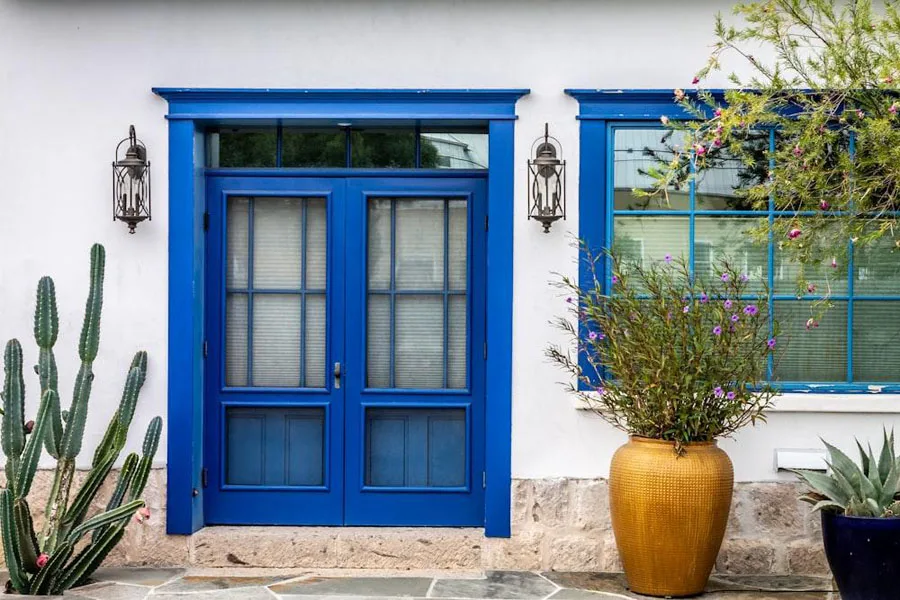 Blue exterior double front doors with glass windows