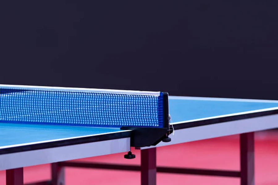 Blue tournament-ready table tennis table from side angle