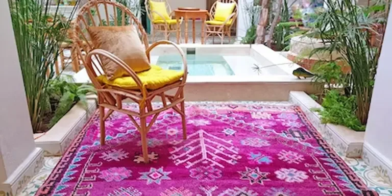 Bright pink patterned Moroccan floor rug in a home foyer