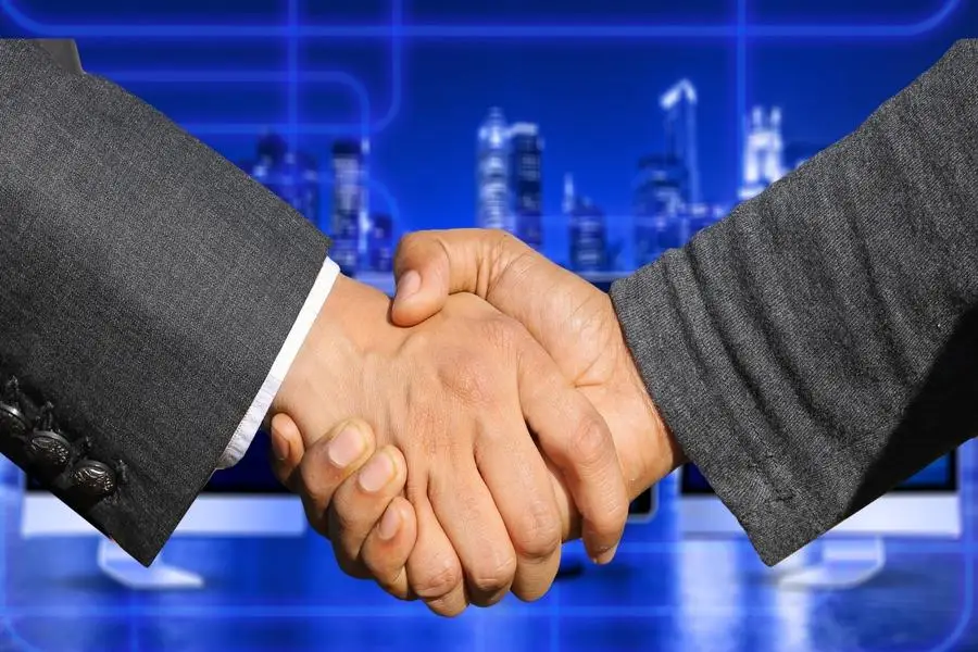 Business partners shaking hands in agreement