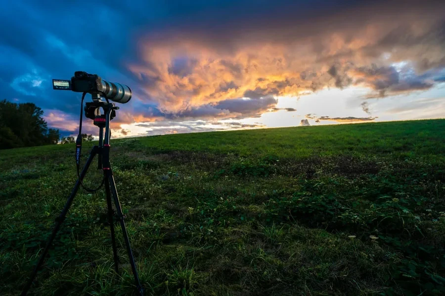 Camera mounted on a tripod outside in a field