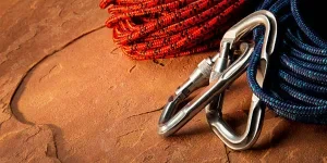 Carabiners attached to climbing ropes on ground