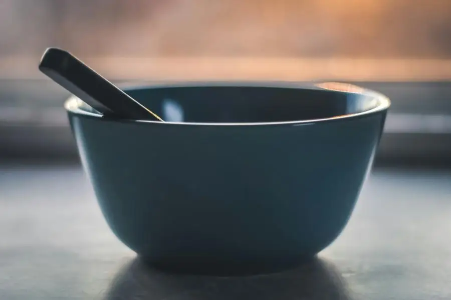 Ceramic mixing bowl with spoon utensil