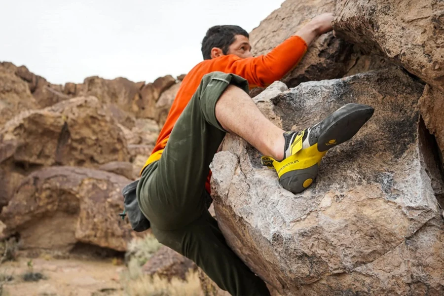 Climber scaling a rock with climbing accessories