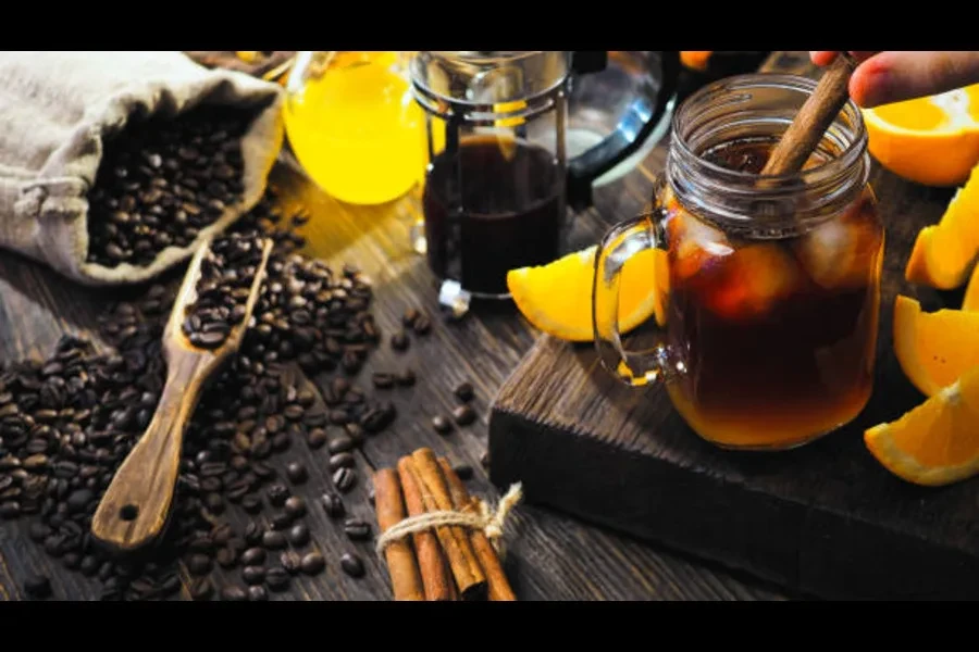 Coffee beans on a board with a mug on its side