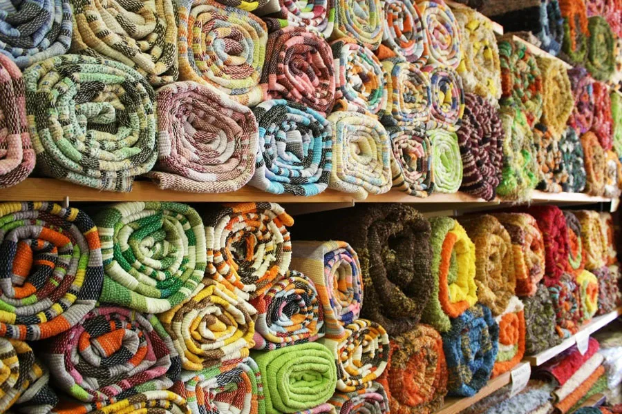 Colorful rugs on a display shelf