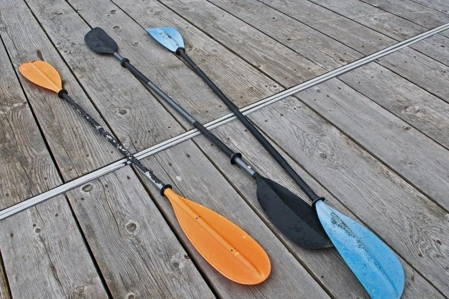 Different kayak paddle blade shapes on a deck