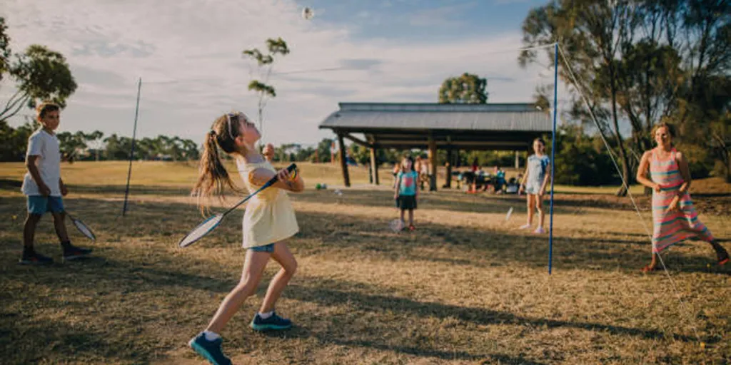 Bir parkta badminton seti kullanan aile