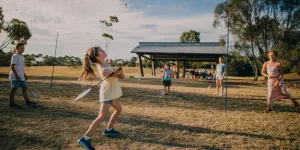Bir parkta badminton seti kullanan aile