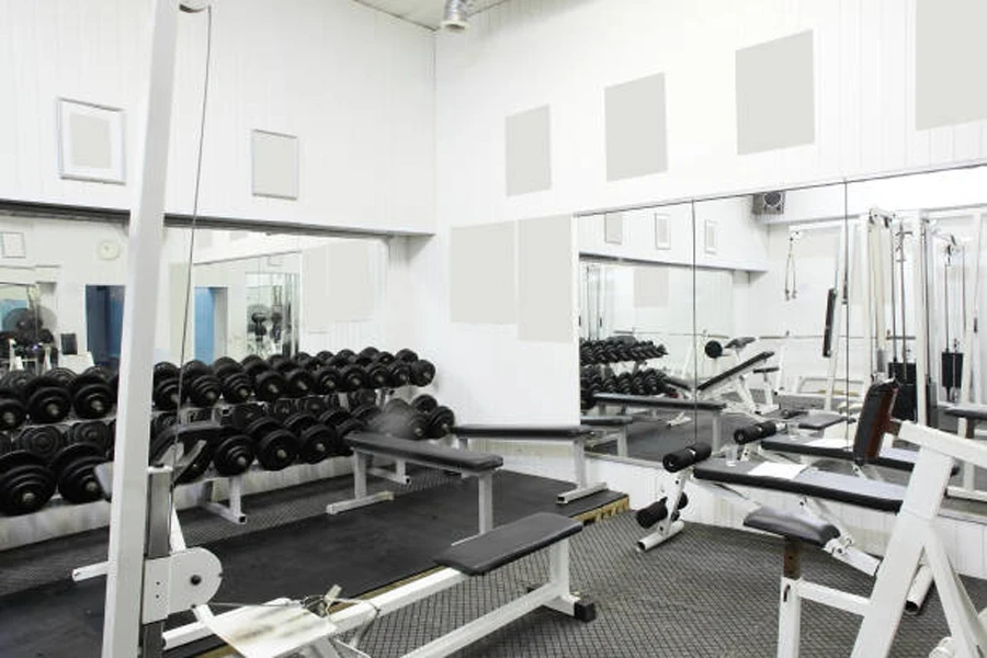Full-length wall mirrors set up in weightlifting area