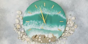 Green home decor wall clock with pebble aesthetics