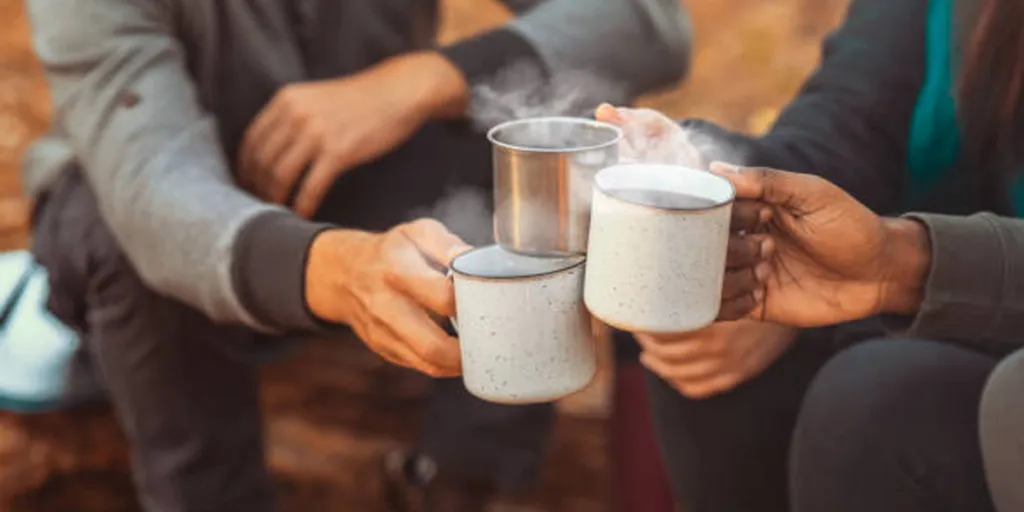Group of friends with camping cups in cold weather
