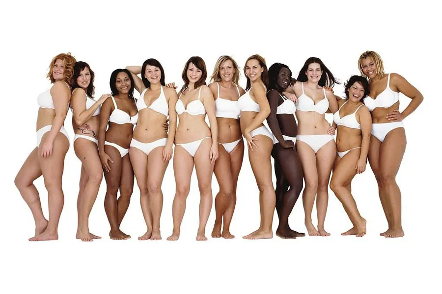 Group of women standing side by side in white undergarments
