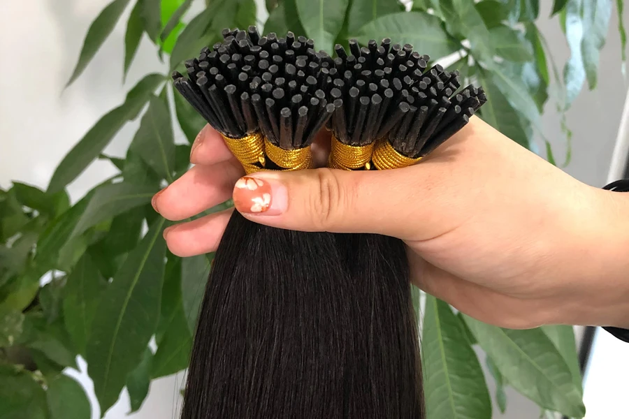 Hand holding microlink hair extensions