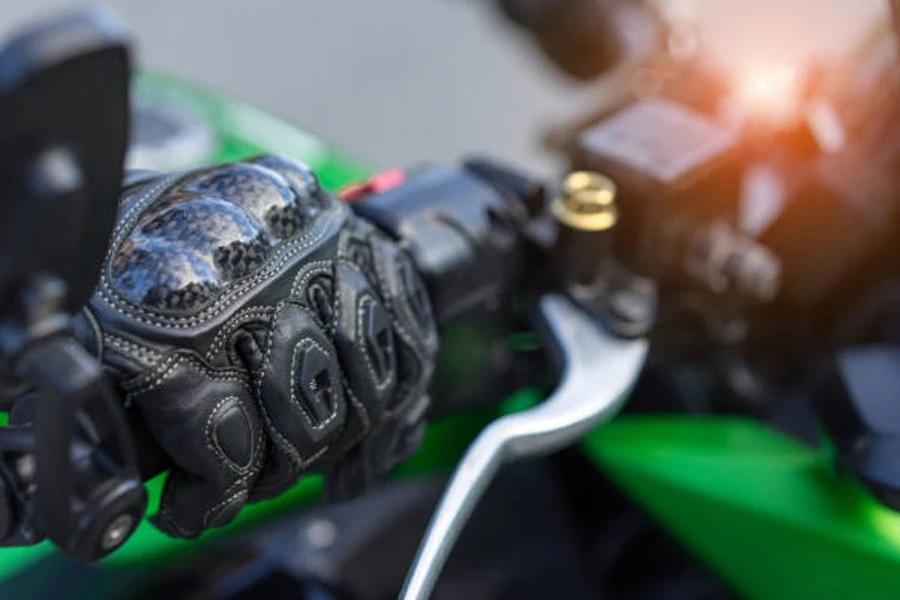 Heated motorcycle glove wrapped around handlebars of motorcycle