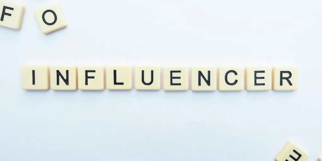 Influencer spelled out in Scrabble tiles