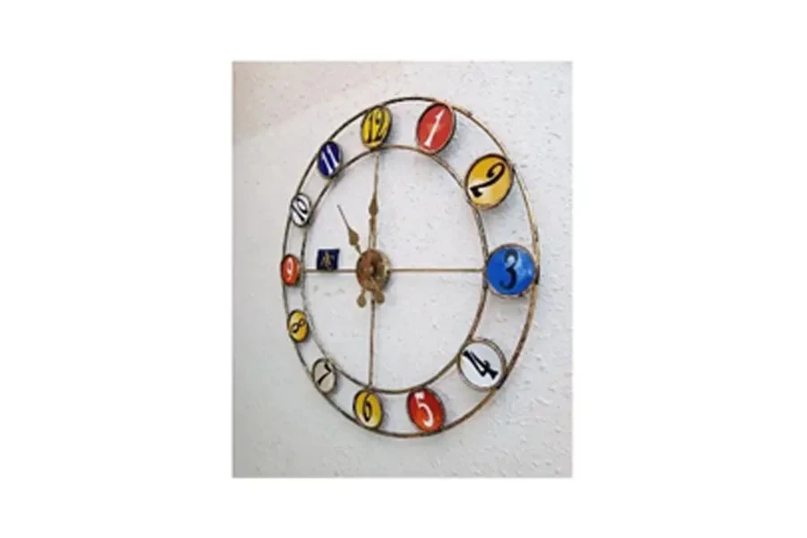 Iron-framed wall clock with numbers on round colored backgrounds