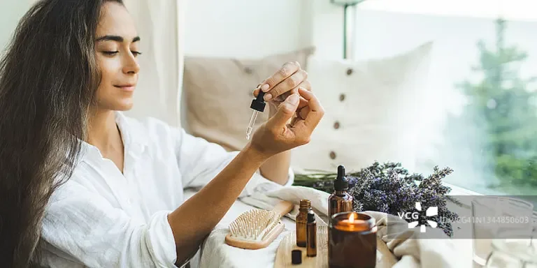 Lady dabbing an essential oil onto her wrist
