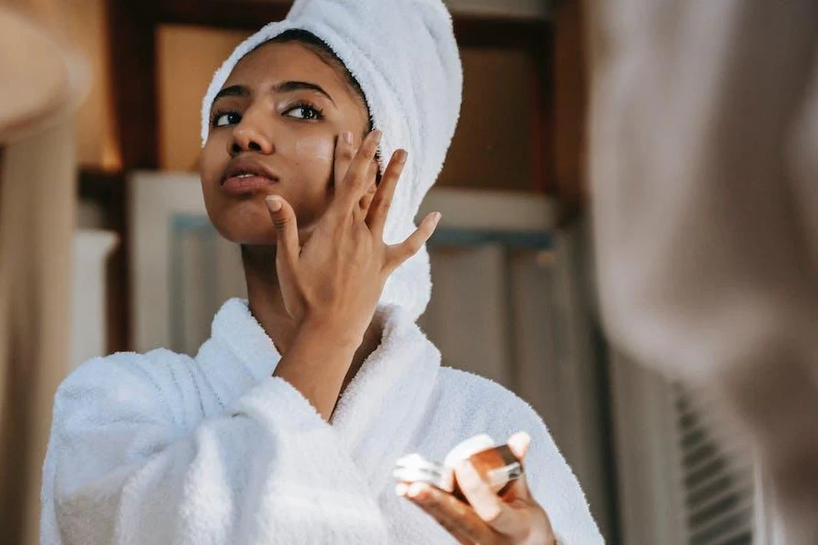 Lady hydrating her skin with a cream moisturizer