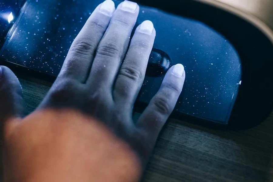 Lady placing hands in an LED nail dryer