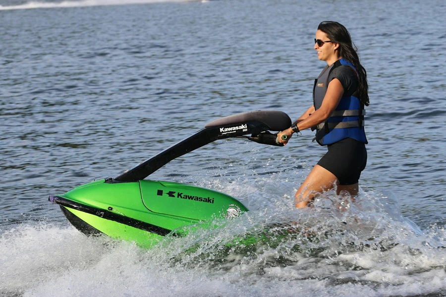 Señora usando una moto acuática verde brillante