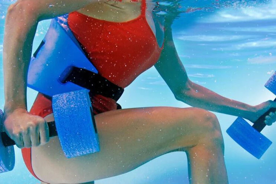 Lady using a water jogging belt and aqua dumbbells