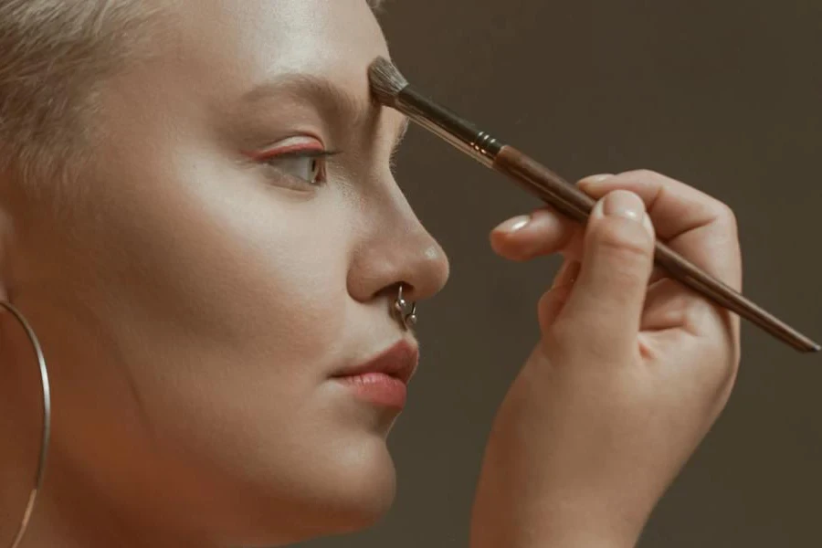 Lady using concealer on her forehead