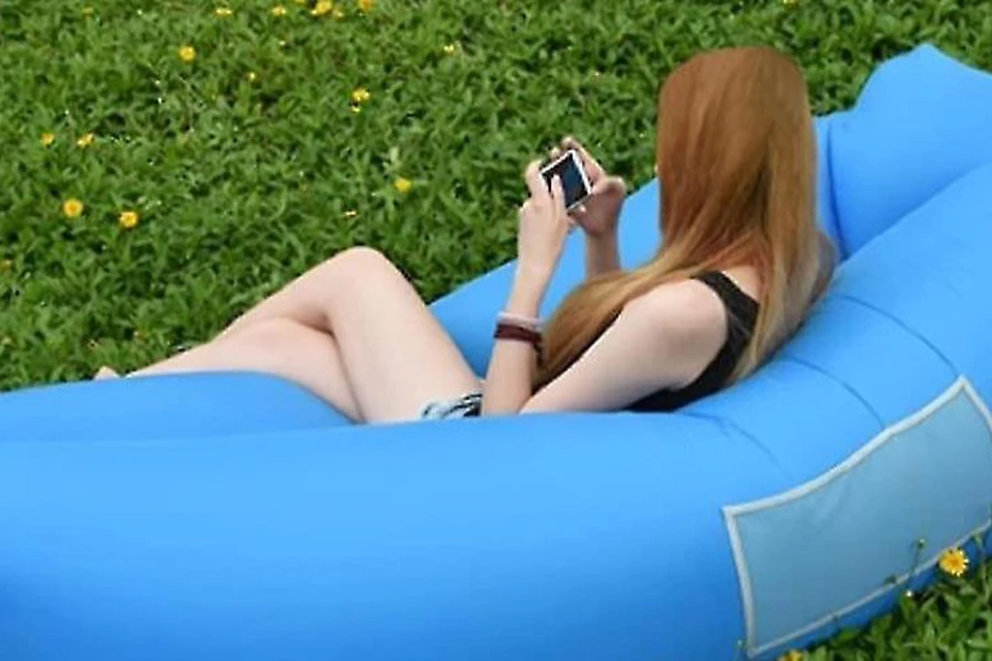 Lady using her phone while on an air sofa