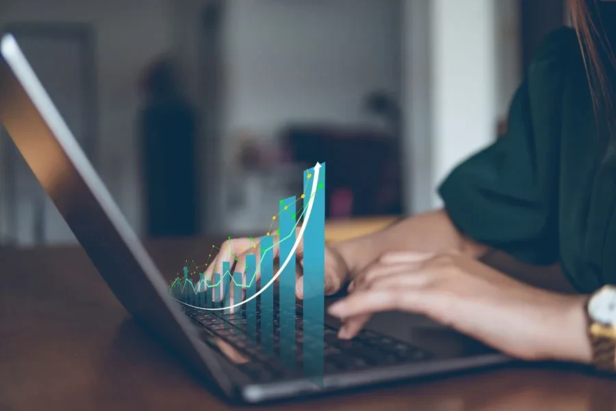 Lady with laptop projecting a rising graph