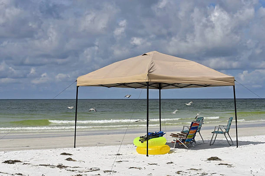 Large beach cabana tent with chairs and toys inside