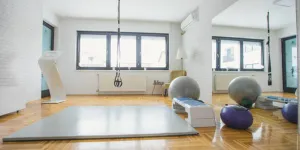 Gran colchoneta de gimnasia gris instalada en un estudio casero