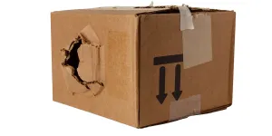 Large hole in a damaged cardboard box