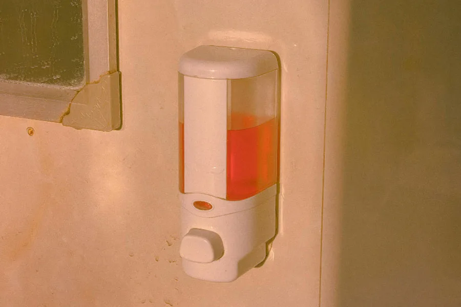 Liquid hand soap in white plastic wall soap dispenser