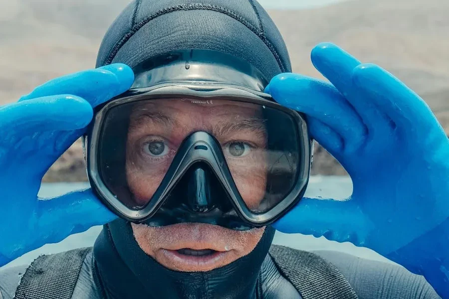 Man adjusting diving mask on his face