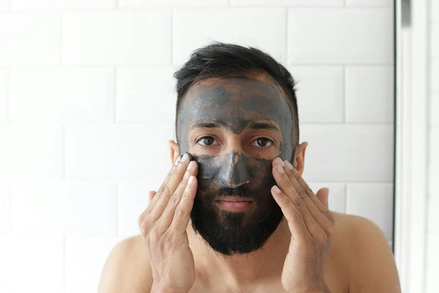 Man applying a facemask in the mirror