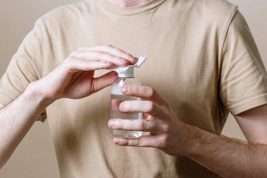 Man holding a bottle of micellar water