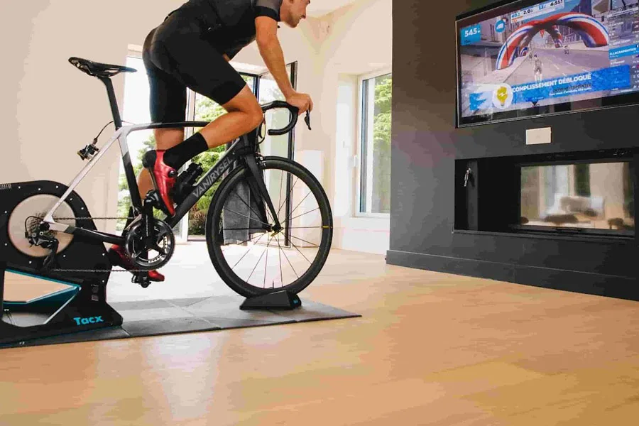 Man training indoors with a bike trainer