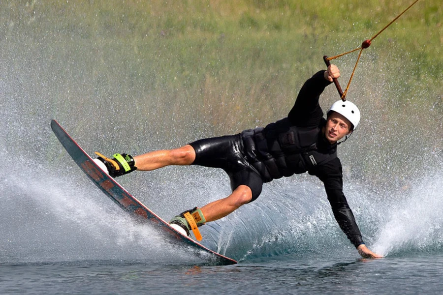 Man wakeboarding in a black wetsuit
