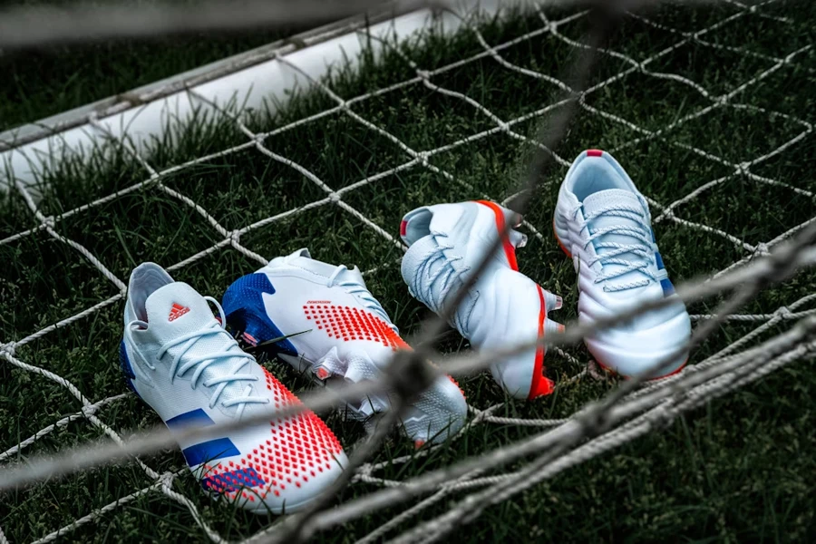 Multiple soccer shoes suspended on a net